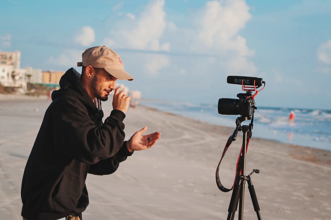man-in-black-jacket-holding-camera-during-daytime-mfwsmddn-ro